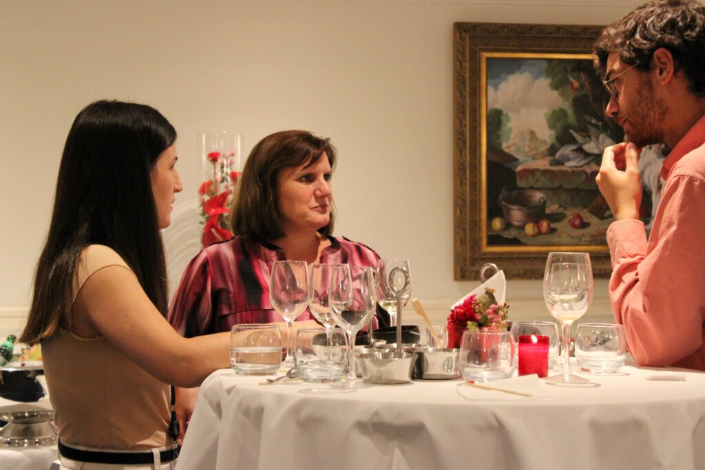 CSE’s president Gabriella Civico talking with two other attendees while enjoying the appetizers