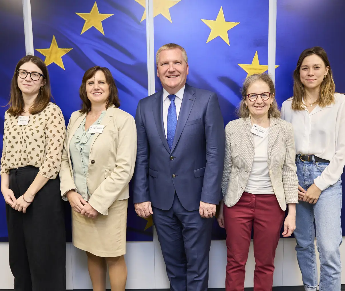 Civil Society Europe team with a European partner in front of the EU flag